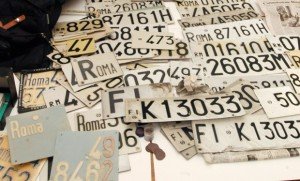 ROME, ITALY: An Italian policeman presents car's number plates, 21 December 2003 in the police headquarters in Rome, after the discovery of a huge weapons cache containing also around 100 kilogrammes of explosives, 200 detonators, hand grenades, a small M12 machine gun, police and carabinieri uniforms, computers and hard discs, and pamphlets claiming responsibility for several attacks, discovered during a raid last night, on a house belonging to the Red Brigades, the country's most feared extremist movement. Documents belonging to Nadia Desdemona Lioce were also found. Her arrest in March re-launched the inquiry into the murders of two Italian labour ministry officials Massimo D'Antona and Marco Biagi, who were killed respectively in Rome in 1999 and Bologna in 2002. AFP PHOTO/Andreas SOLARO (Photo credit should read ANDREAS SOLARO/AFP/Getty Images)